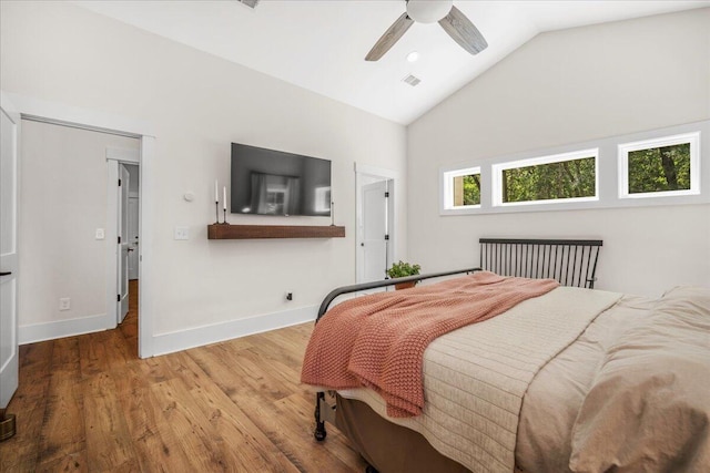 bedroom with wood finished floors, baseboards, a ceiling fan, and high vaulted ceiling
