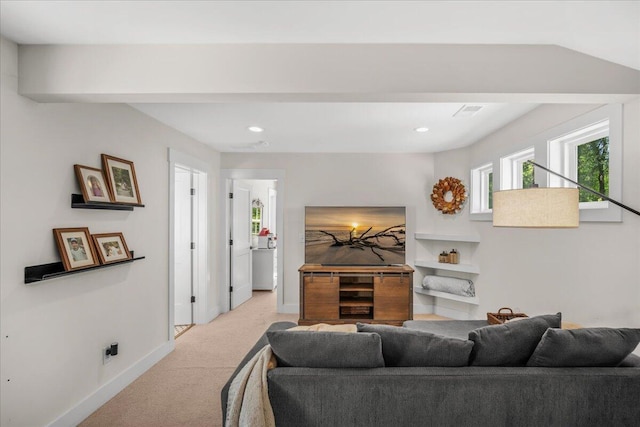 living room with light colored carpet, plenty of natural light, baseboards, and recessed lighting