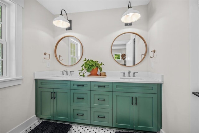 full bathroom with baseboards and double vanity