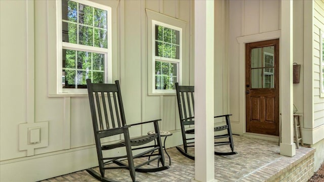 view of exterior entry featuring covered porch