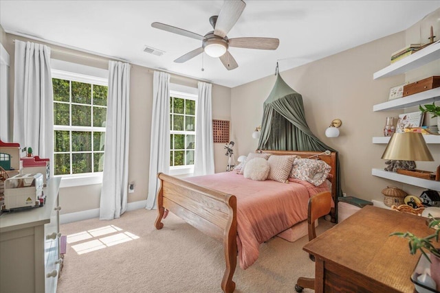 bedroom with light carpet, baseboards, and a ceiling fan