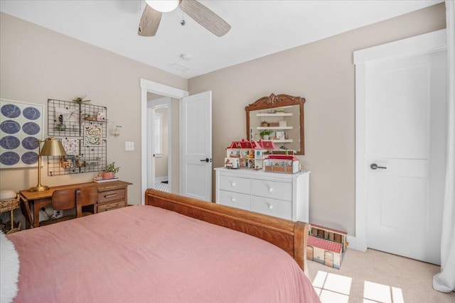 bedroom with light colored carpet and a ceiling fan