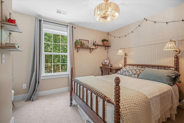 bedroom with carpet, baseboards, and a chandelier