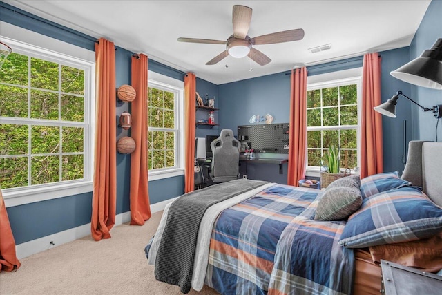 carpeted bedroom with baseboards and ceiling fan