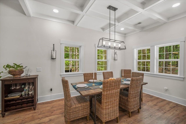 dining room featuring coffered ceiling, baseboards, wood finished floors, beamed ceiling, and a chandelier
