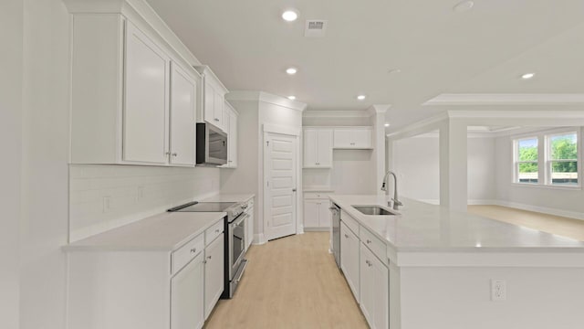 205 Bilge Rd, Ridgeville, SC 29472 - kitchen featuring stainless steel appliances, backsplash, an island with sink, light countertops, and crown molding