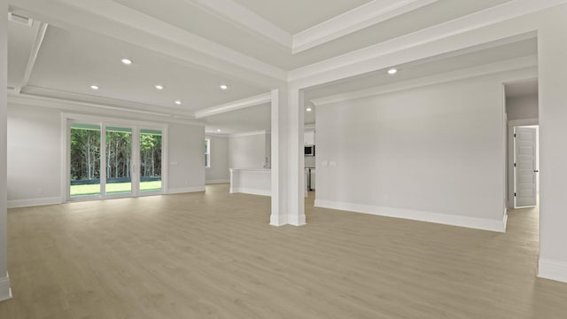 205 Bilge Rd, Ridgeville, SC 29472 - unfurnished living room featuring crown molding, light wood-style flooring, a tray ceiling, and recessed lighting