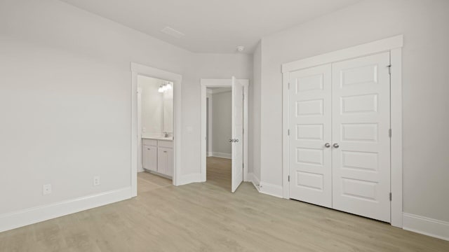 205 Bilge Rd, Ridgeville, SC 29472 - unfurnished bedroom featuring light wood-type flooring, a closet, and connected bathroom
