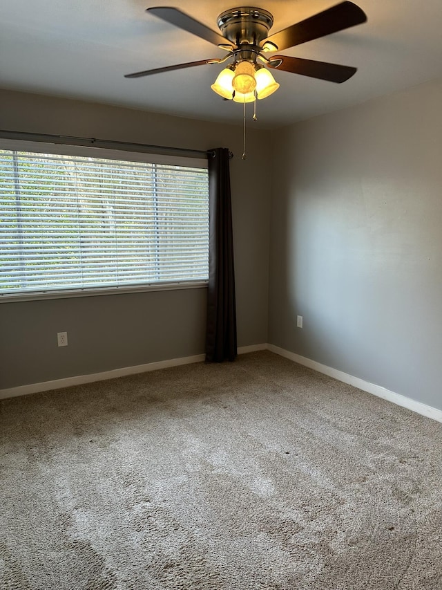 carpeted empty room with ceiling fan