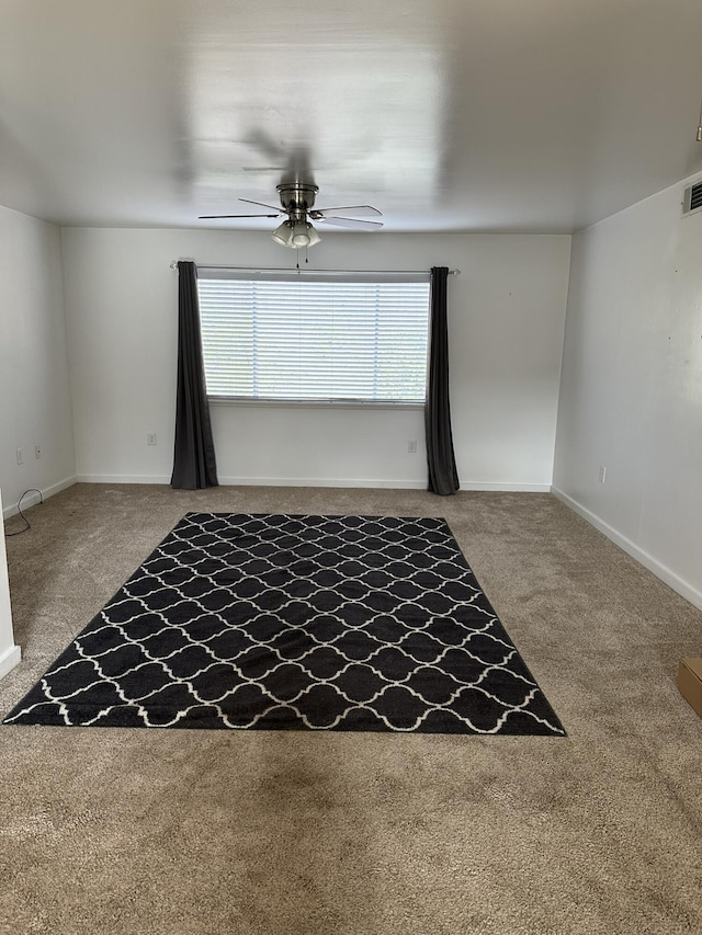 carpeted empty room featuring ceiling fan