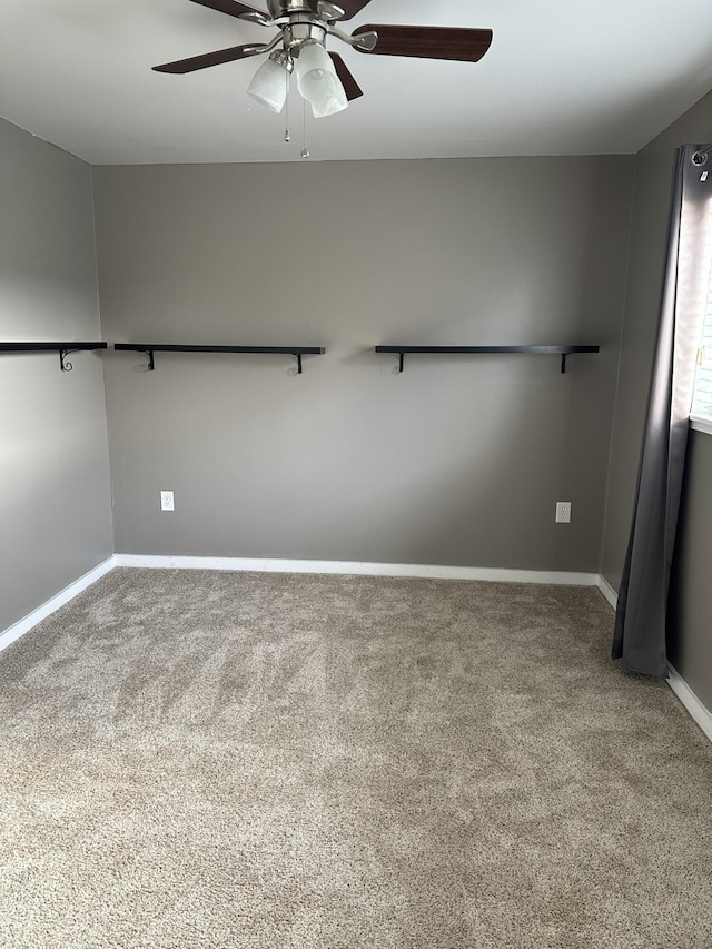 spare room featuring carpet floors and ceiling fan