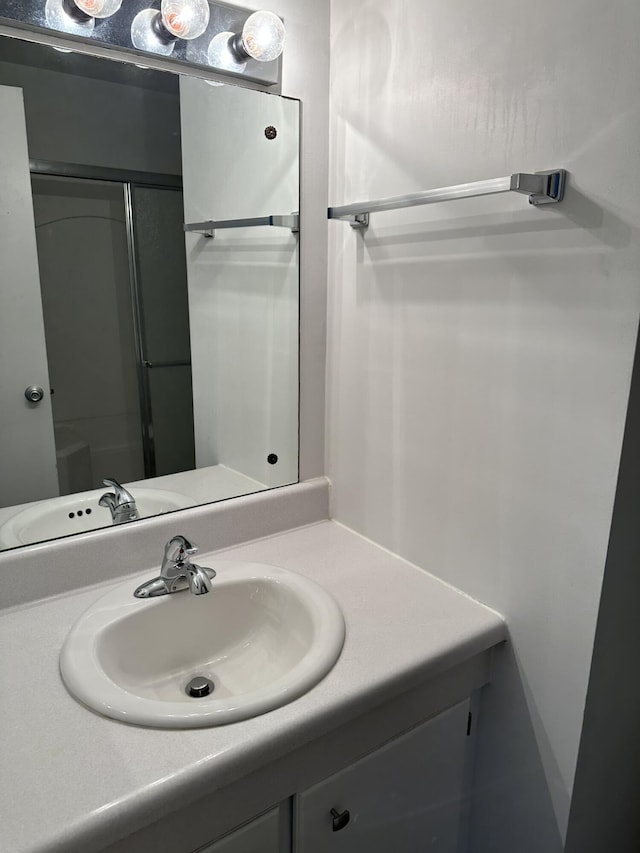 bathroom featuring vanity and an enclosed shower