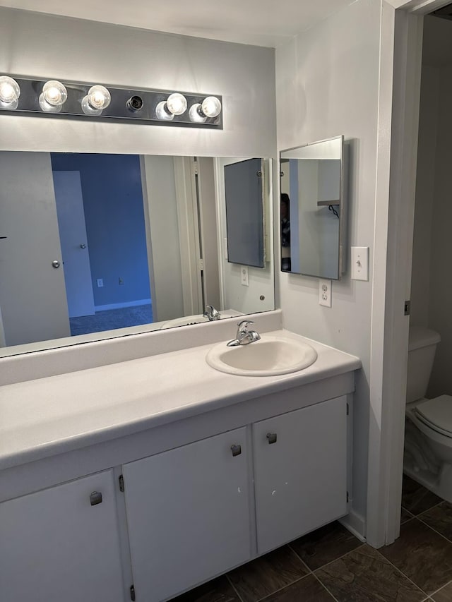 bathroom with vanity and toilet