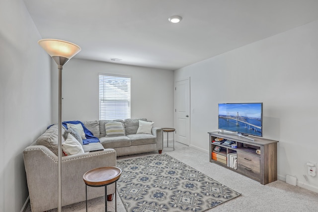 living area featuring visible vents, baseboards, and carpet floors