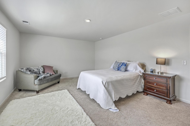 bedroom featuring visible vents, baseboards, and carpet