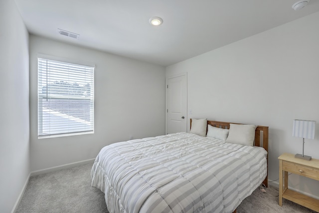 carpeted bedroom with visible vents and baseboards