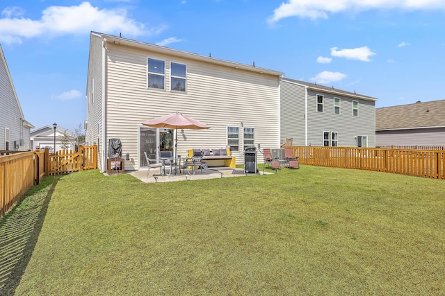 back of house with a patio, a lawn, and a fenced backyard