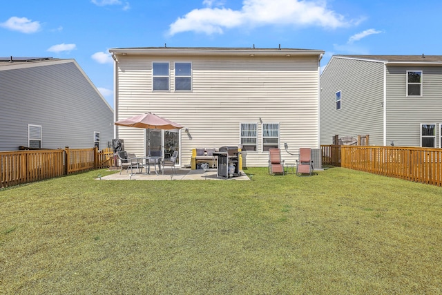 back of property featuring a yard, a patio, and a fenced backyard