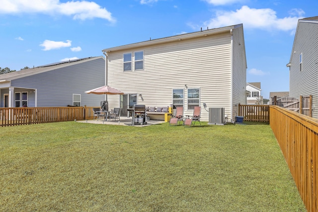 rear view of property featuring a yard, central AC unit, a fenced backyard, and a patio area