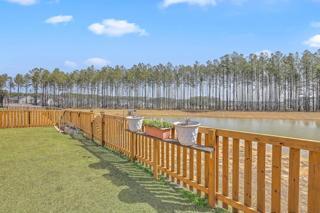 view of yard with fence and a water view