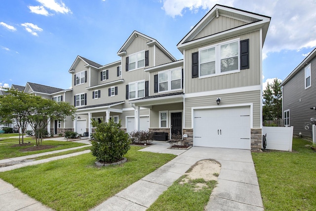 4117 Rigsby Ln, Charleston, SC 29414 - view of front of property with board and batten siding, driveway, a front yard, and stone siding