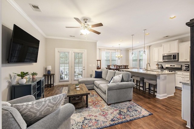 4117 Rigsby Ln, Charleston, SC 29414 - living area featuring a ceiling fan, ornamental molding, dark wood-type flooring, a chandelier, and recessed lighting