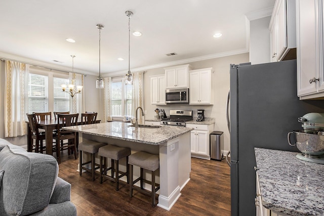 4117 Rigsby Ln, Charleston, SC 29414 - kitchen with appliances with stainless steel finishes, a chandelier, a breakfast bar area, white cabinets, and crown molding