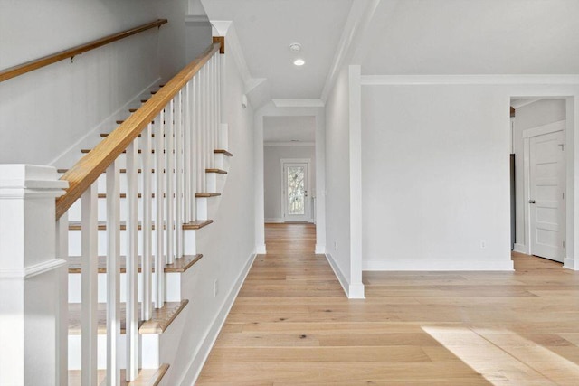 foyer entrance with light wood finished floors, baseboards, stairway, ornamental molding, and recessed lighting