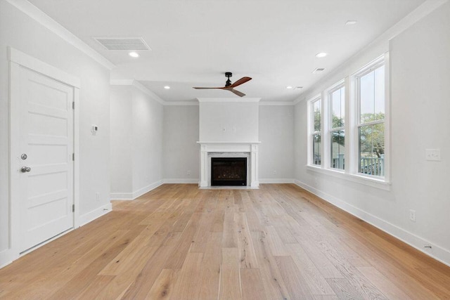 unfurnished living room featuring light wood-type flooring, visible vents, and crown molding