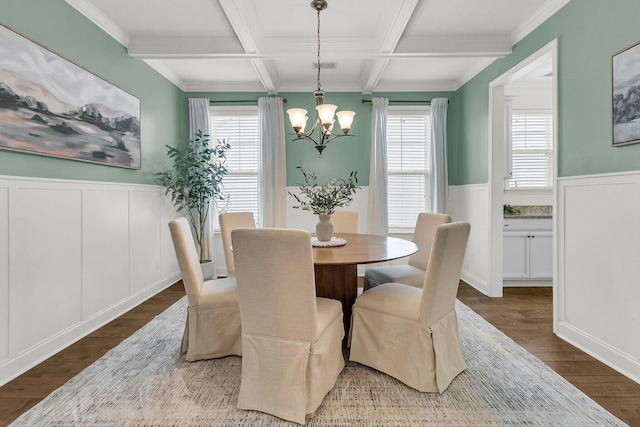 dining area featuring hardwood / wood-style floors, an inviting chandelier, coffered ceiling, ornamental molding, and beam ceiling