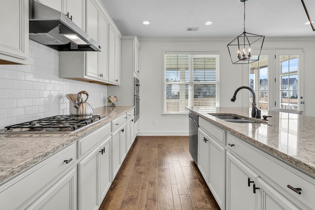 kitchen with light stone countertops, stainless steel appliances, sink, dark hardwood / wood-style floors, and white cabinetry