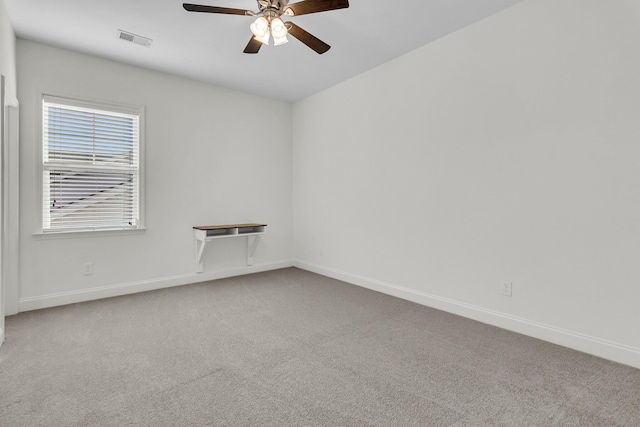 spare room featuring ceiling fan and carpet floors