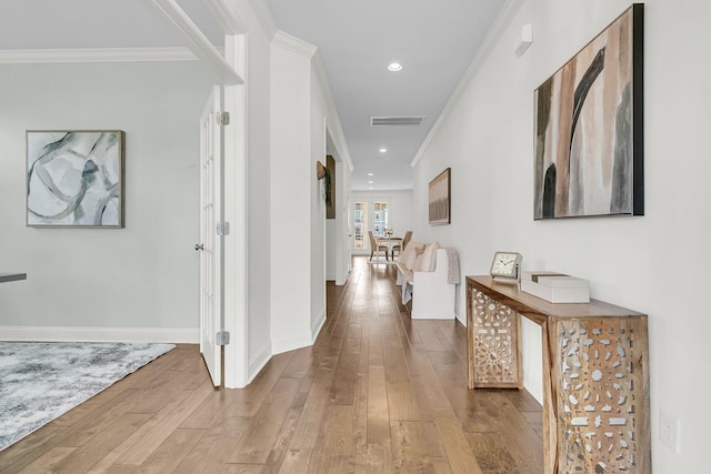 hallway featuring crown molding and hardwood / wood-style floors