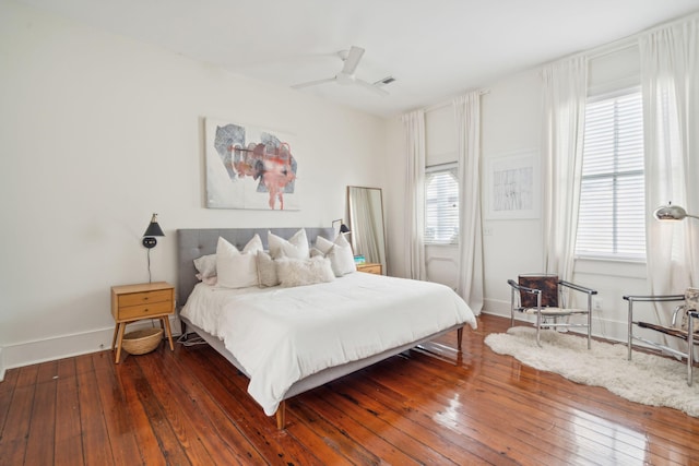 bedroom featuring hardwood / wood-style floors, multiple windows, and ceiling fan