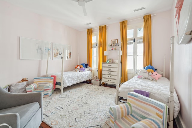 bedroom with ceiling fan and multiple windows