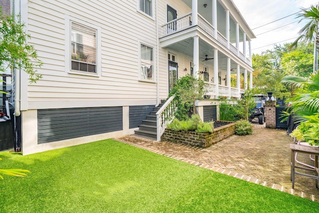 view of yard featuring a balcony and a patio