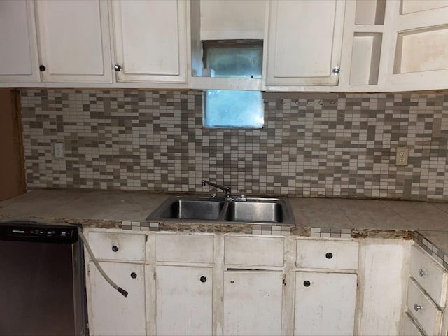 kitchen featuring sink, backsplash, dishwasher, and white cabinets