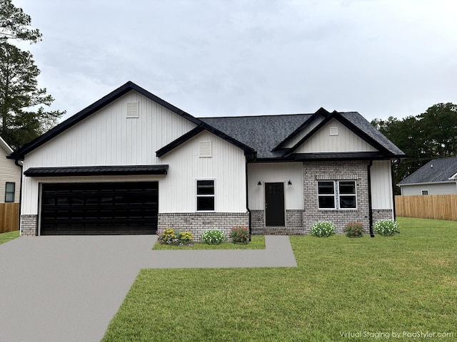 view of front of property featuring a garage and a front yard