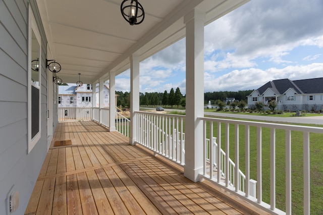 wooden deck with a yard and a residential view