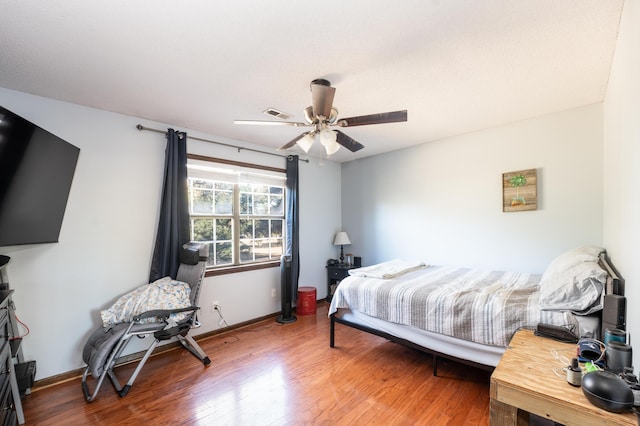 bedroom with hardwood / wood-style floors and ceiling fan