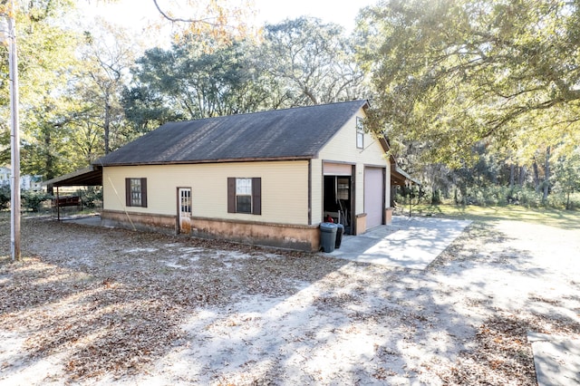 view of side of home with a carport