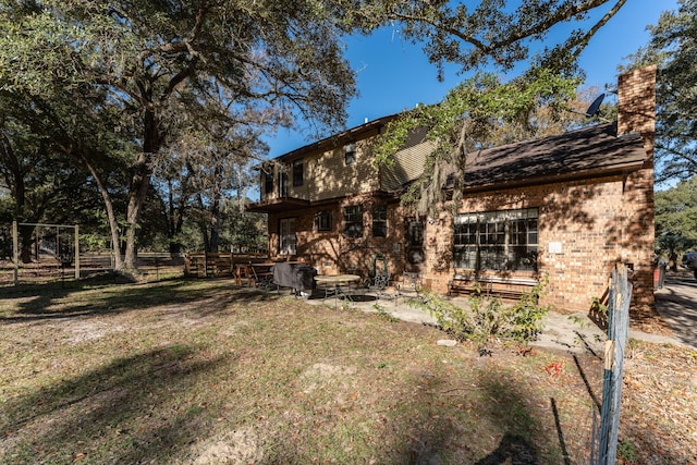 back of house featuring a yard