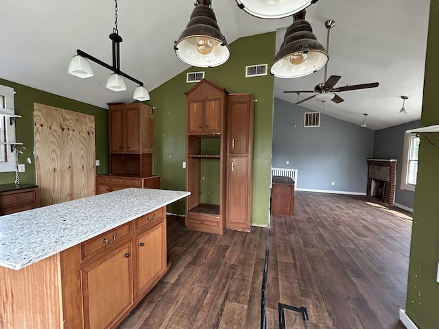 2204 Dover St, North Charleston, SC 29405 - kitchen featuring a ceiling fan, a fireplace, dark wood-style flooring, pendant lighting, and baseboards