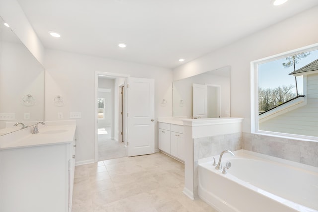 full bathroom featuring recessed lighting, a sink, two vanities, baseboards, and a bath