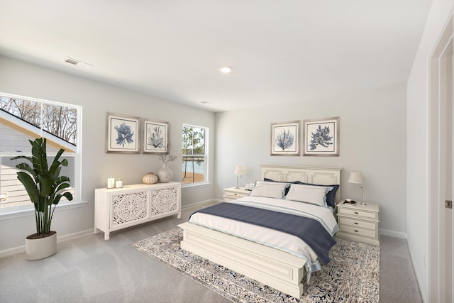 bedroom with carpet floors, visible vents, and baseboards