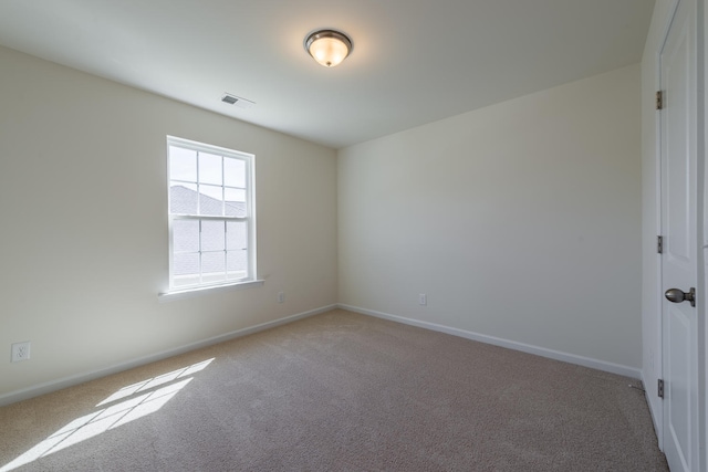 empty room featuring baseboards, visible vents, and carpet flooring