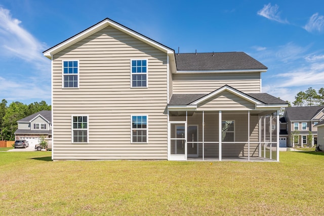 rear view of house with a sunroom, roof with shingles, and a yard