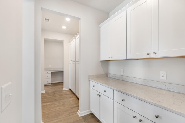 interior space featuring recessed lighting, visible vents, light wood-style flooring, and baseboards