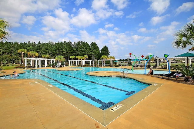 community pool with a patio area and a pergola