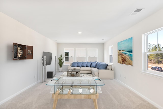 carpeted living room with visible vents and baseboards